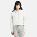 Vintage white Timberland Brushed Back Logo Hoodie for Women. Soft cotton-polyester blend for comfort. Brushed back fleece for warmth. Relaxed, cropped silhouette. Drawcord-adjustable hood. Iridescent Timberland logo