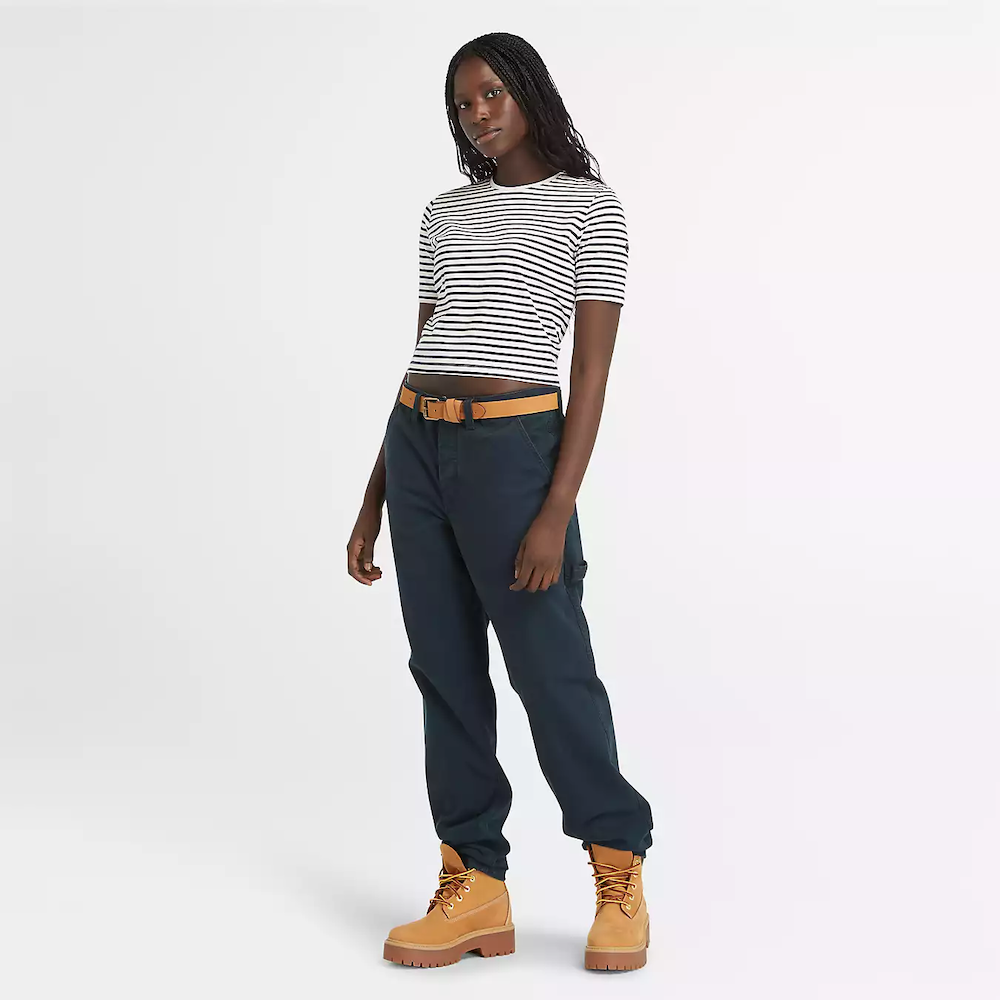 Striped Timberland Crop Short Sleeve Tee for Women. Soft, breathable cotton blend fabric. Relaxed fit for comfort. Cropped silhouette for a trendy look. Ribbed collar for a snug fit. Classic striped pattern for nautical style