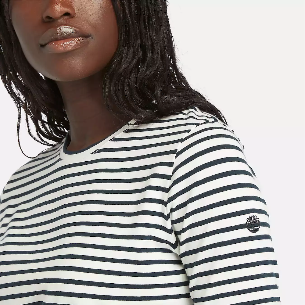 Striped Timberland Crop Short Sleeve Tee for Women. Soft, breathable cotton blend fabric. Relaxed fit for comfort. Cropped silhouette for a trendy look. Ribbed collar for a snug fit. Classic striped pattern for nautical style