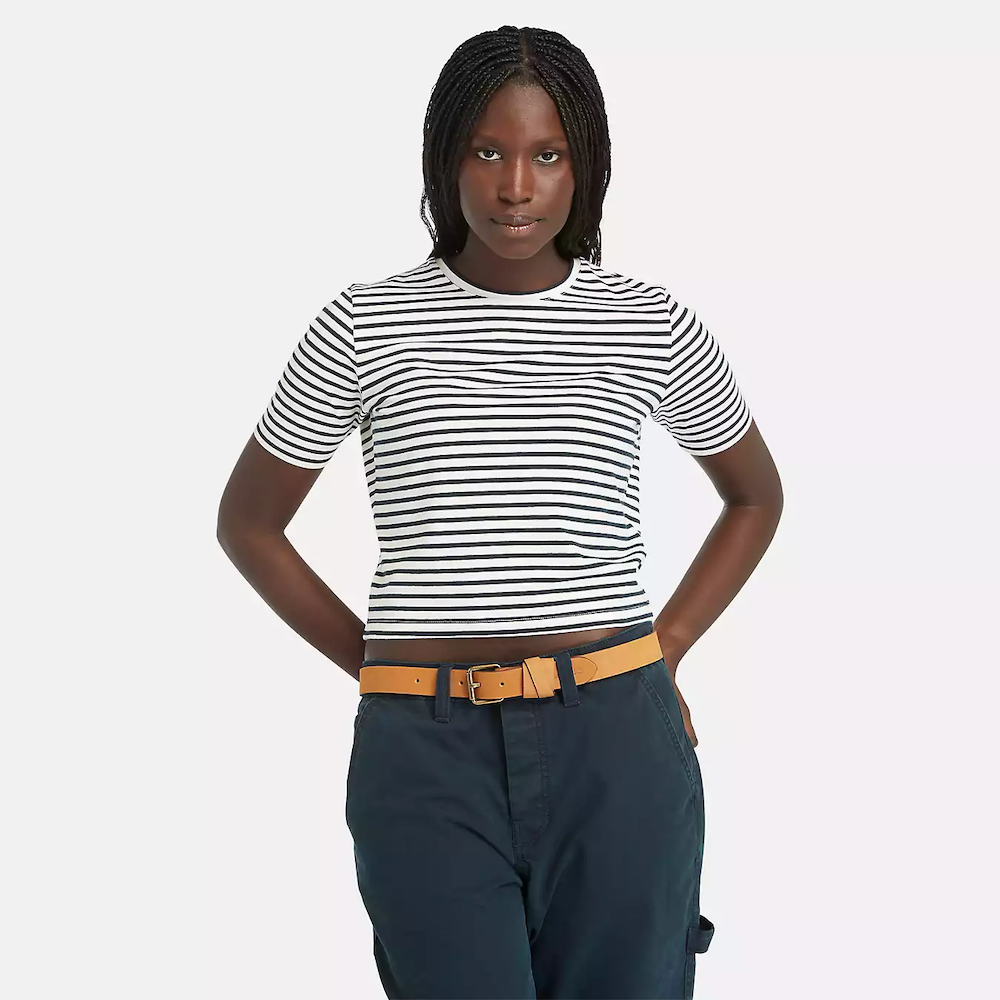Striped Timberland® Crop Short Sleeve Tee for Women. Soft, breathable cotton blend fabric. Relaxed fit for comfort. Cropped silhouette for a trendy look. Ribbed collar for a snug fit. Classic striped pattern for nautical style