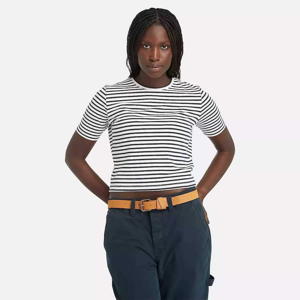 Striped Timberland Crop Short Sleeve Tee for Women. Soft, breathable cotton blend fabric. Relaxed fit for comfort. Cropped silhouette for a trendy look. Ribbed collar for a snug fit. Classic striped pattern for nautical style