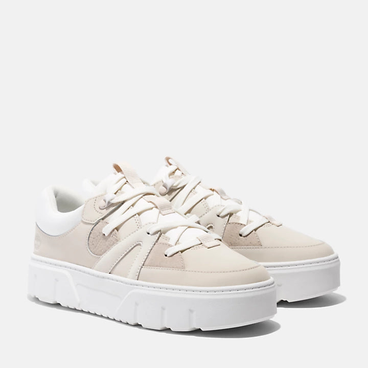 Beige and white Timberland® Laurel Court Lace-Up Sneaker for Women. Premium nubuck leather upper for durability and luxury. ReBOTL™ fabric lining made with recycled plastic for sustainability. 100% Recycled PET laces. OrthoLite® footbed for cushioning.