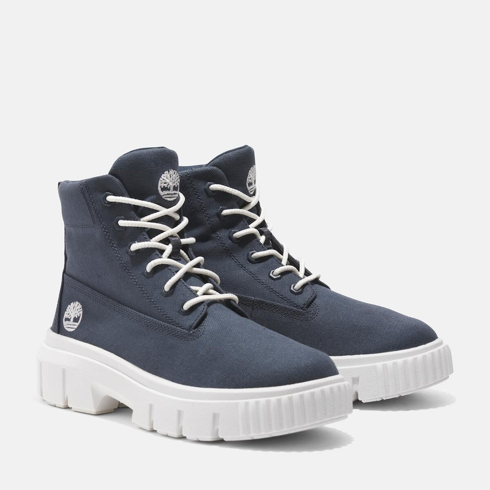 Dark blue Timberland® Greyfield Mid Lace-Up Boot for Women. Canvas upper for relaxed breathability. Dark blue color for modern style. Lace-up closure for secure fit. Comfortable footbed for support and cushioning. Durable rubber outsole for traction