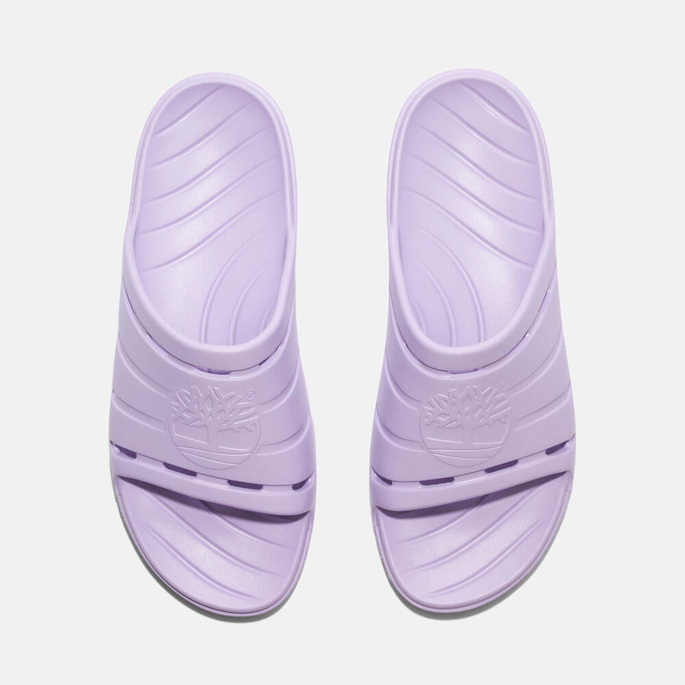 Timberland® Get Outslide Slide Sandal for Women in Purple. Purple slide sandal with one-piece EVA upper and outsole for lightweight comfort. Perfect for casual wear and lounging.