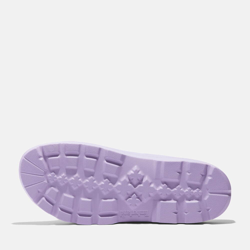Timberland Get Outslide Slide Sandal for Women in Purple. Purple slide sandal with one-piece EVA upper and outsole for lightweight comfort. Perfect for casual wear and lounging.