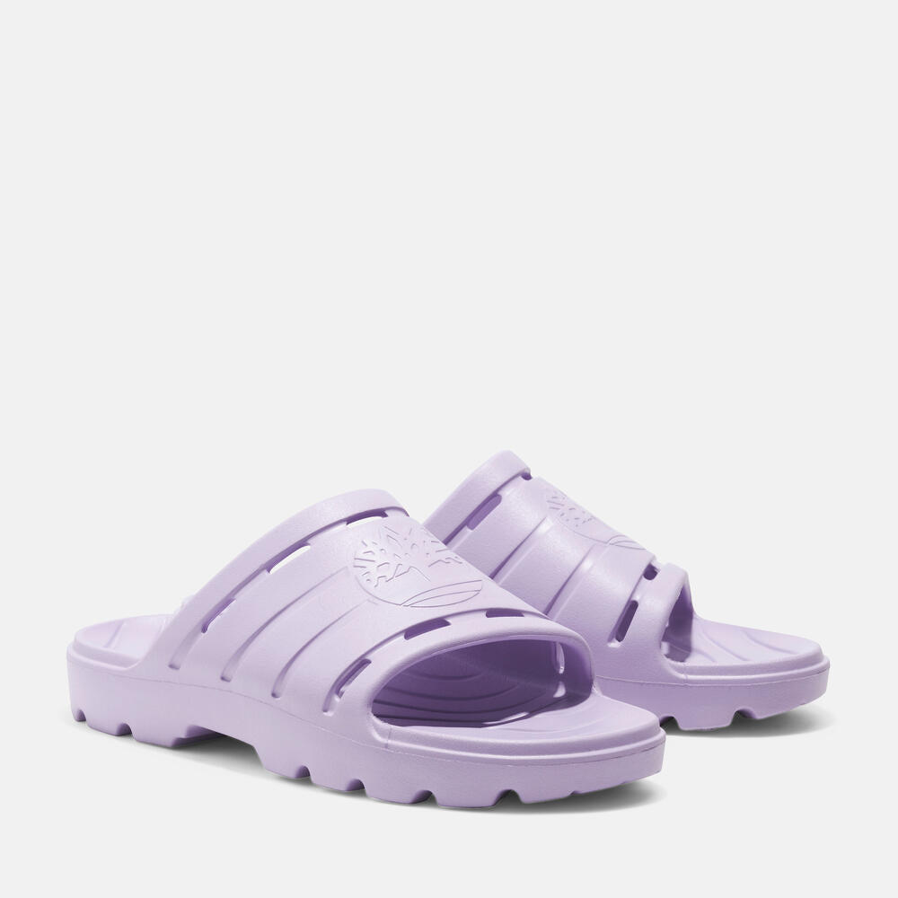 Timberland® Get Outslide Slide Sandal for Women in Purple. Purple slide sandal with one-piece EVA upper and outsole for lightweight comfort. Perfect for casual wear and lounging.