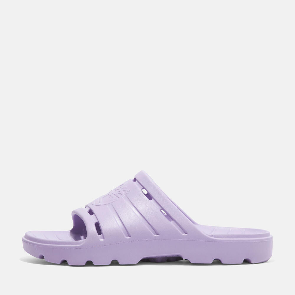 Timberland Get Outslide Slide Sandal for Women in Purple. Purple slide sandal with one-piece EVA upper and outsole for lightweight comfort. Perfect for casual wear and lounging.