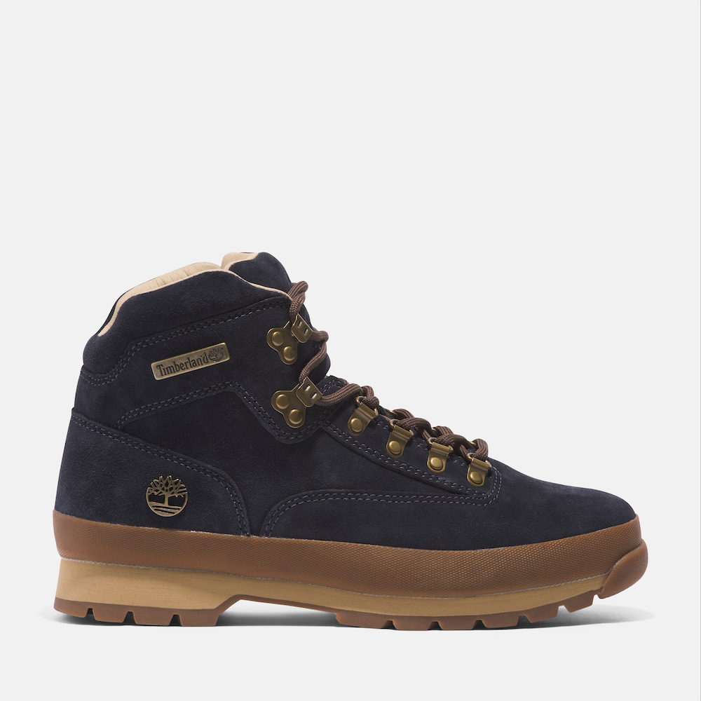 Timberland® C.F. Stead™ Indigo Suede Euro Hiker Mid Lace Up Boot for Men. Mid-cut, dark blue suede hiking boot crafted with premium leather by C.F. Stead™. Features waterproof construction, supportive steel shank, lug sole for grip, and mid-ankle laces for a secure fit.