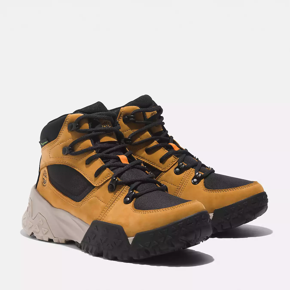 Wheat Timberland Motion Scramble Waterproof Boot. Leather & CORDURA upper for durability. Cushioned midsole & footbed. GreenStride soles for traction & eco-friendliness. TimberGrip outsole for grip. Mid-cut design. Lace-up closure. Wheat colour.