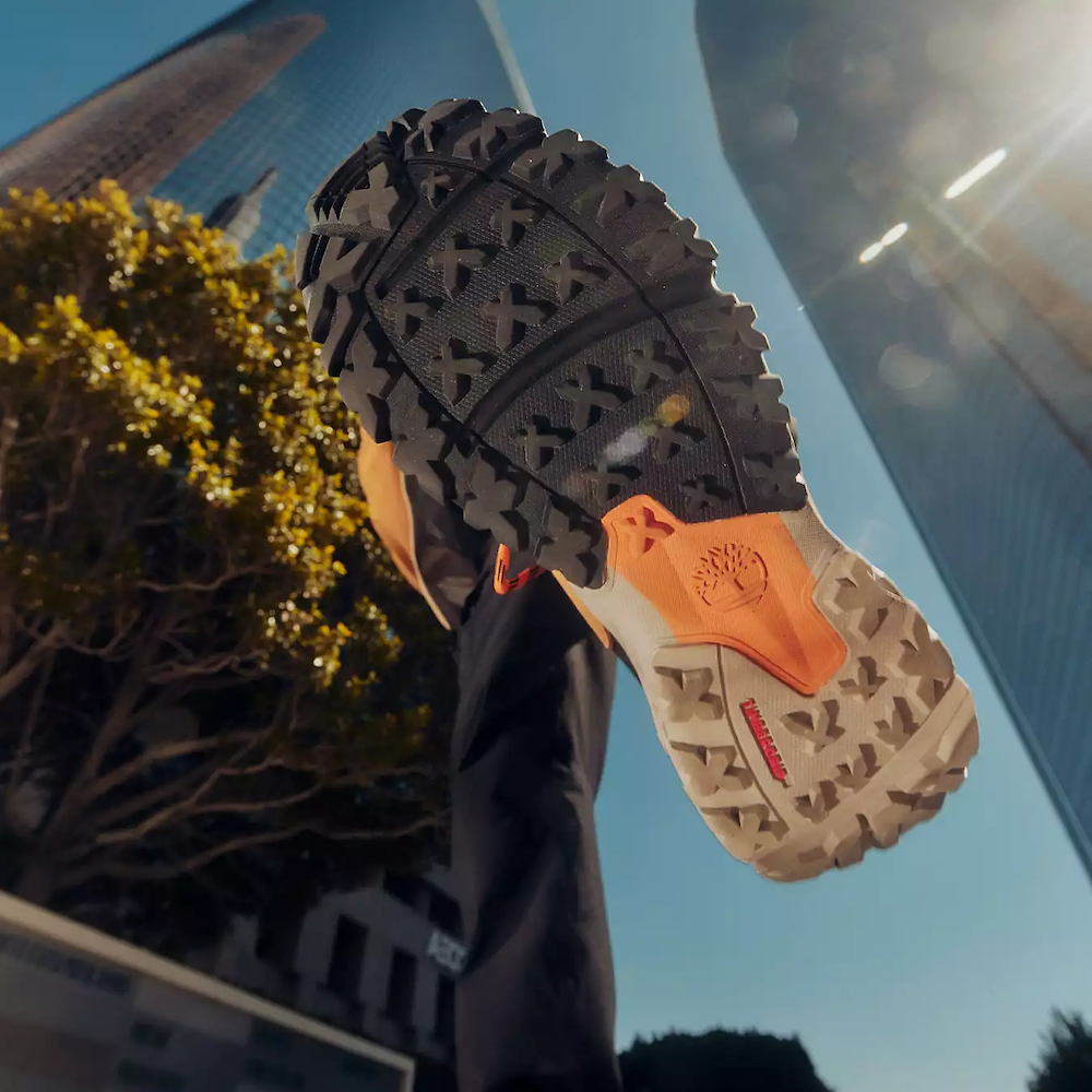 Wheat Timberland Motion Scramble Waterproof Boot. Leather & CORDURA upper for durability. Cushioned midsole & footbed. GreenStride soles for traction & eco-friendliness. TimberGrip outsole for grip. Mid-cut design. Lace-up closure. Wheat colour.