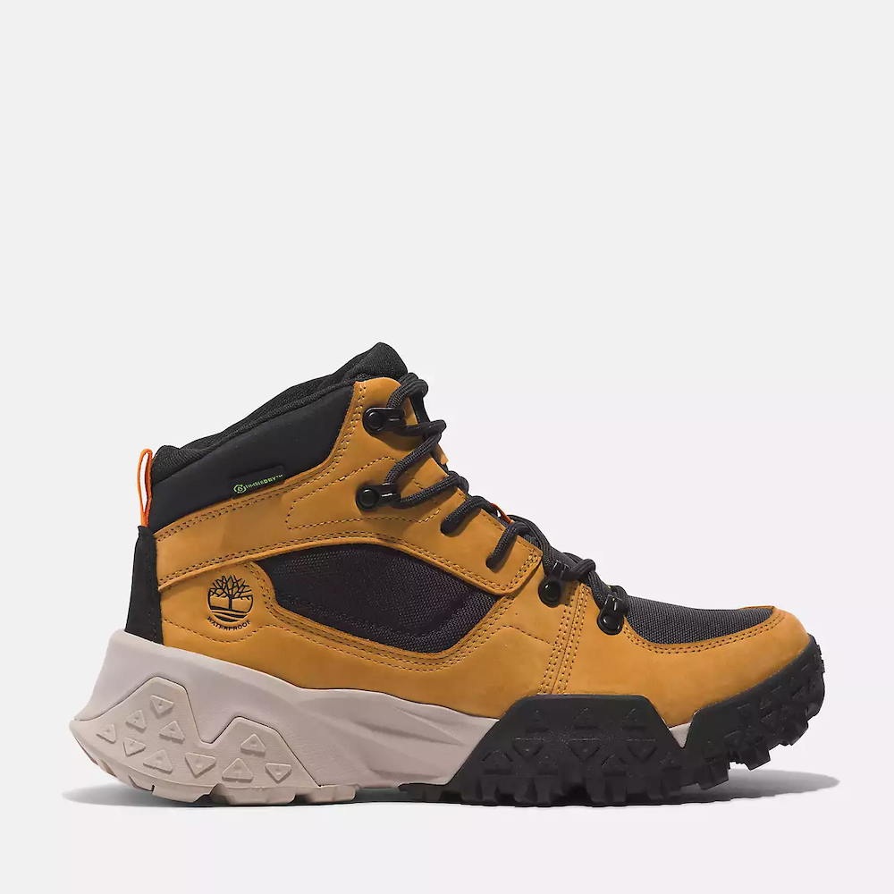 Wheat Timberland Motion Scramble Waterproof Boot. Leather & CORDURA upper for durability. Cushioned midsole & footbed. GreenStride soles for traction & eco-friendliness. TimberGrip outsole for grip. Mid-cut design. Lace-up closure. Wheat colour.