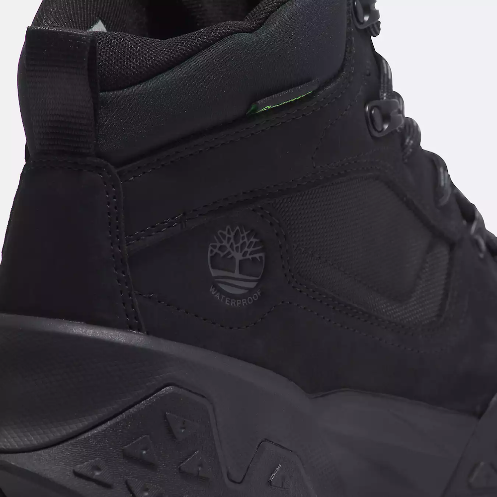 Black Timberland Motion Scramble Waterproof Boot. Leather & CORDURA upper for durability in black. Cushioned midsole & footbed. GreenStride soles for traction & eco-friendliness. TimberGrip outsole for grip. Mid-cut design. Lace-up closure.