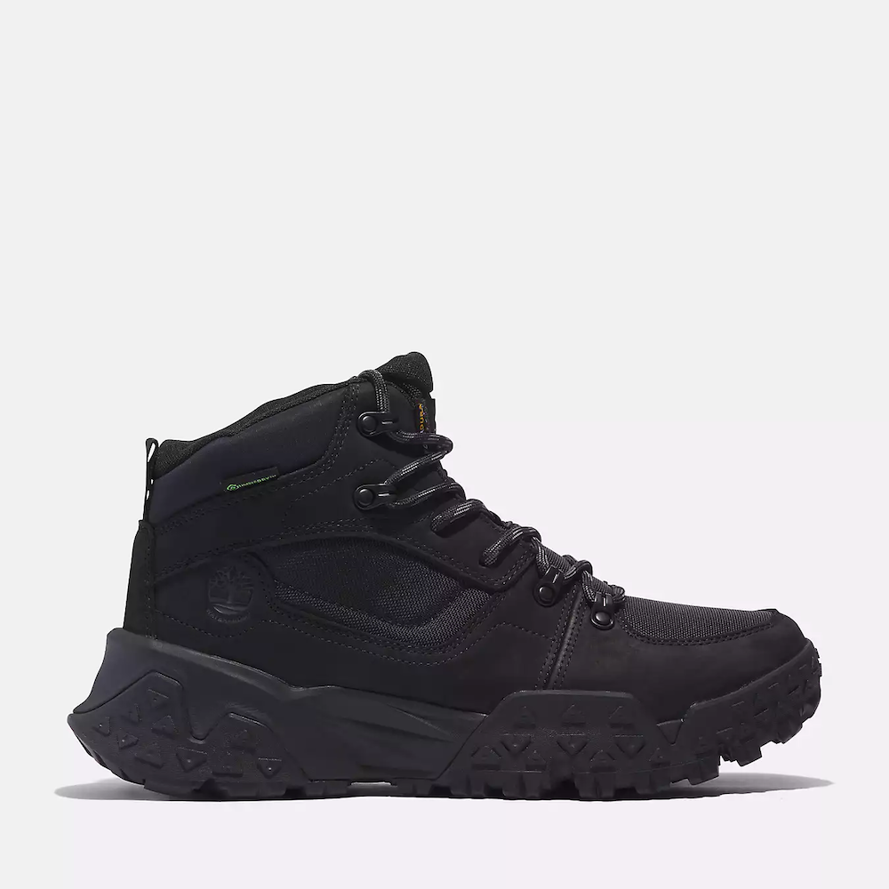 Black Timberland Motion Scramble Waterproof Boot. Leather & CORDURA upper for durability in black. Cushioned midsole & footbed. GreenStride soles for traction & eco-friendliness. TimberGrip outsole for grip. Mid-cut design. Lace-up closure.