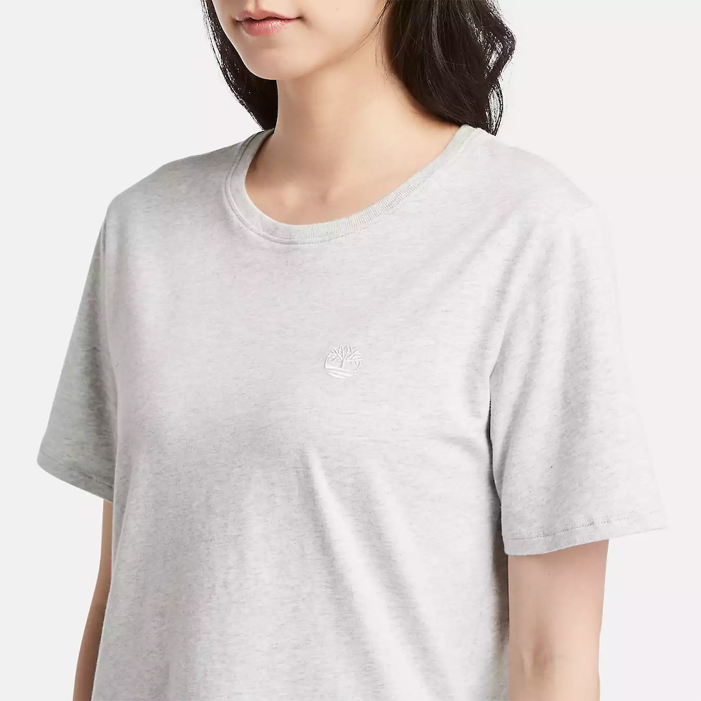 Light grey Timberland Dunstan Short Sleeve Tee for Women. Crewneck t-shirt made from 100% cotton featuring a relaxed, regular fit for comfortable wear.  A ribbed collar adds structure, while a small embroidered Timberland tree logo sits on the chest
