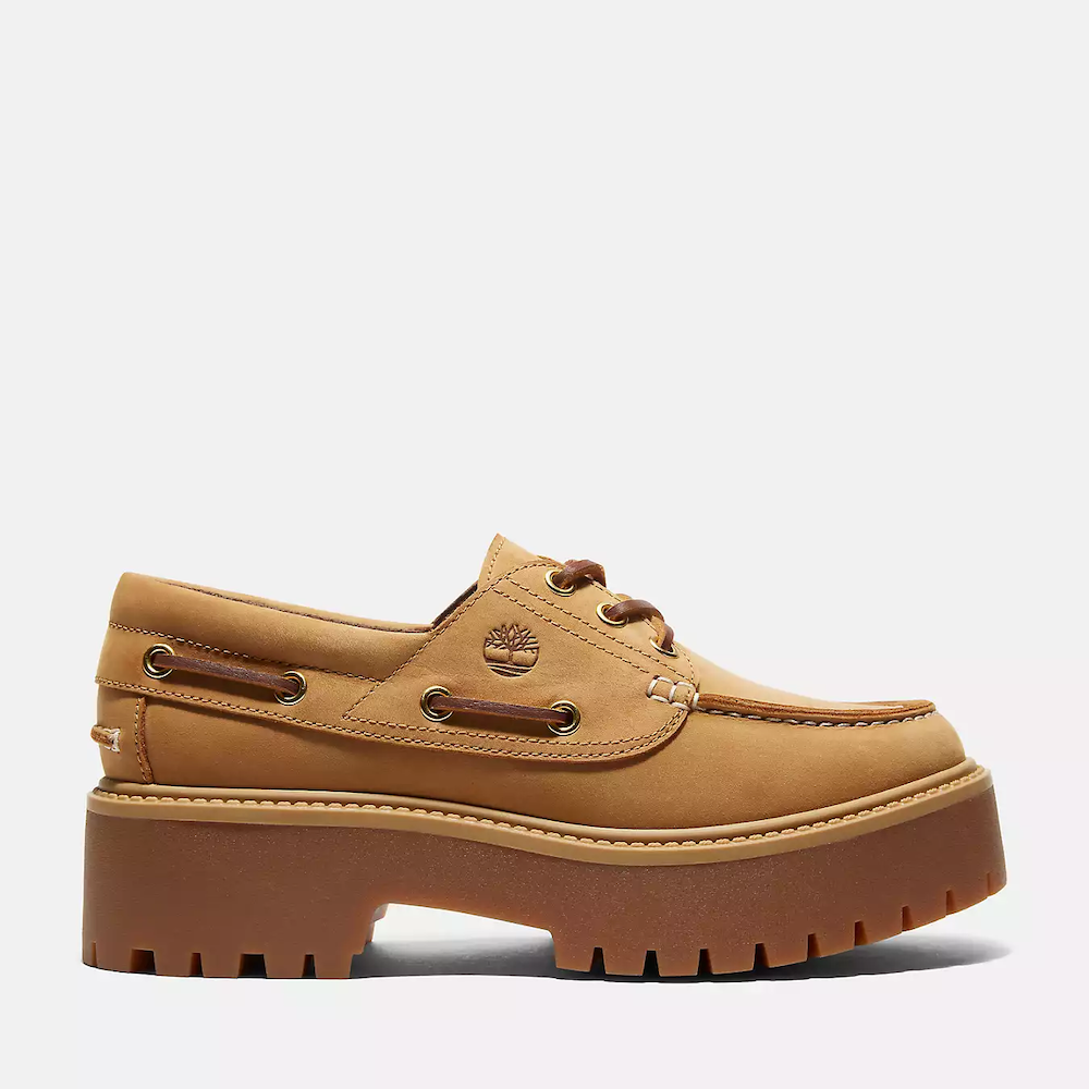 Wheat Timberland® Stone Street Boat Shoe for Women. Premium leather upper for luxury and durability. 3-eye lace-up closure for secure fit. Padded collar for ankle support. Breathable leather lining. OrthoLite® insoles for comfort and moisture management. Chunky rubber sole for traction and durability