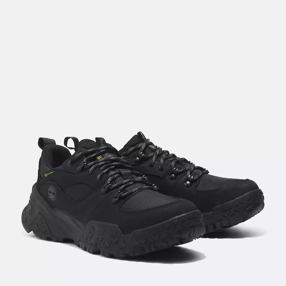Timberland¡ Motion Scramble Waterproof Hiker for Men. Black hiking shoe featuring waterproof leather and fabric upper, lace-up closure for a secure fit, TimberDrywaterproof membrane for dry feet, TimberCushcomfort system for support, and GreenStridesoles made with recycled materials for eco-conscious traction.