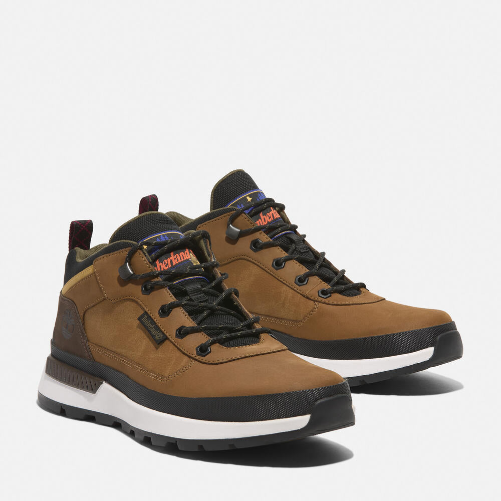 Timberland® Field Trekker Mid Lace-Up Trainer for Men in Brown. Brown leather trainer with ReBOTL™ lining and OrthoLite® footbed.  Mid-cut design for added support.