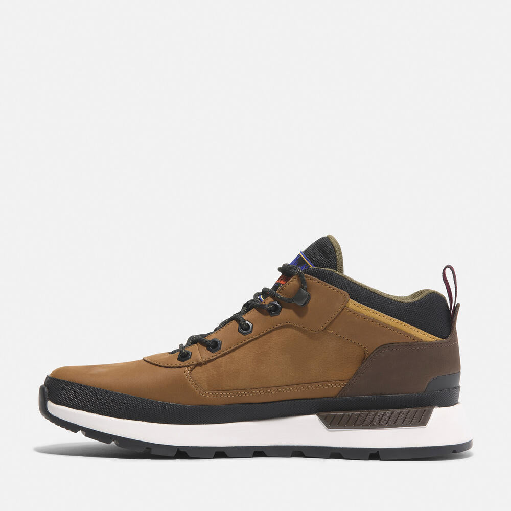 Timberland® Field Trekker Mid Lace-Up Trainer for Men in Brown. Brown leather trainer with ReBOTL lining and OrthoLite® footbed.  Mid-cut design for added support.