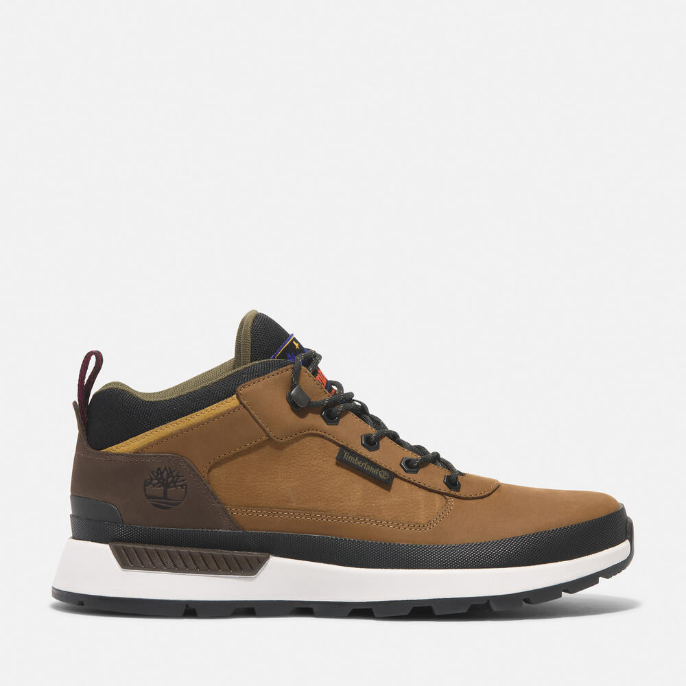 Timberland® Field Trekker Mid Lace-Up Trainer for Men in Brown. Brown leather trainer with ReBOTL™ lining and OrthoLite® footbed.  Mid-cut design for added support.