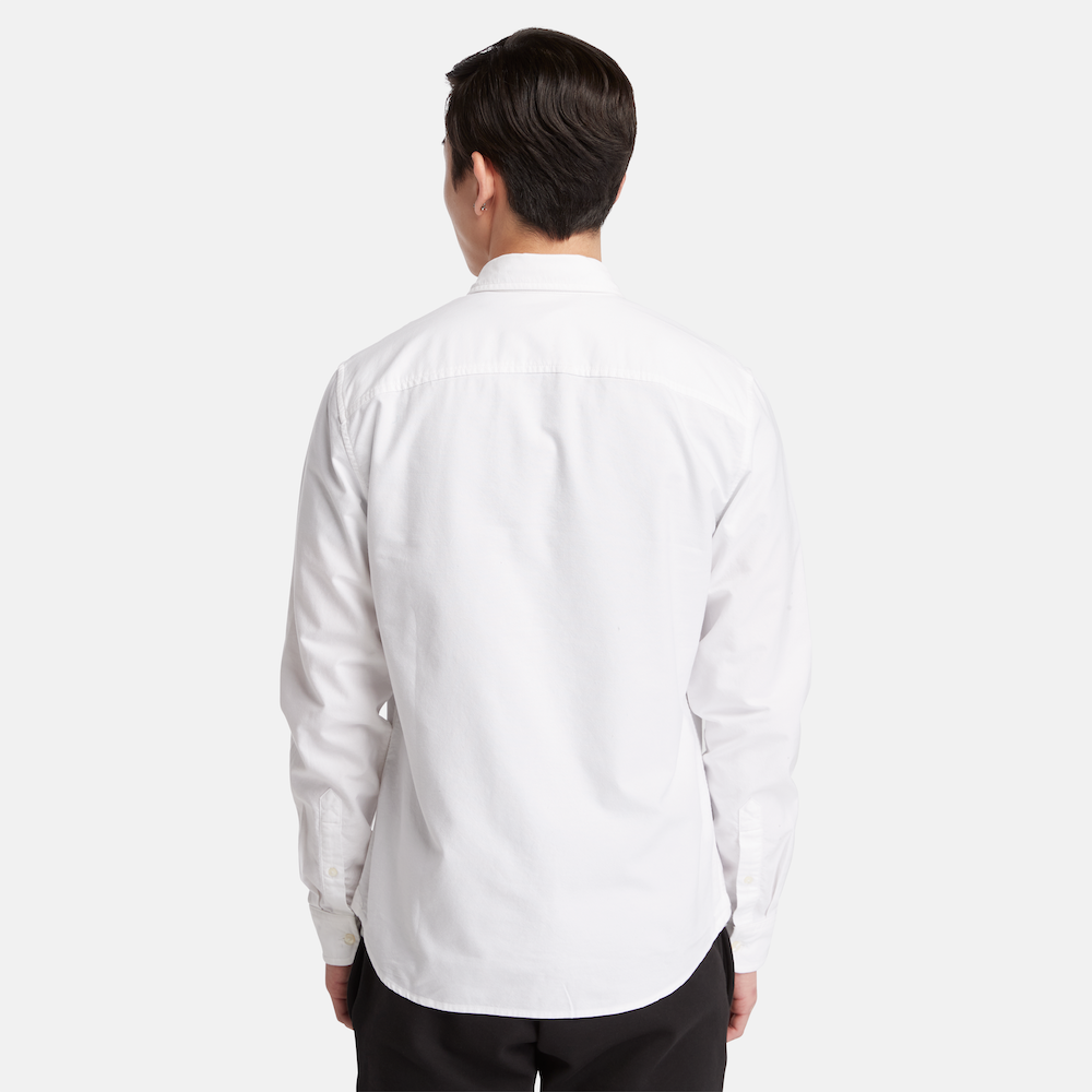 TimberlandÂ® Long Sleeve Oxford Shirt for Men in White. White oxford shirt featuring a relaxed regular fit for comfortable wear. Made from 100% organic cotton for a soft and breathable feel. Features a mini button-down collar, rounded cuffs, and faux shell buttons for a polished look.  TimberlandÂ® tree logo embroidered on the chest for subtle branding. Pairs well with jeans, chinos, or dress pants for work, casual outings, or layered looks.