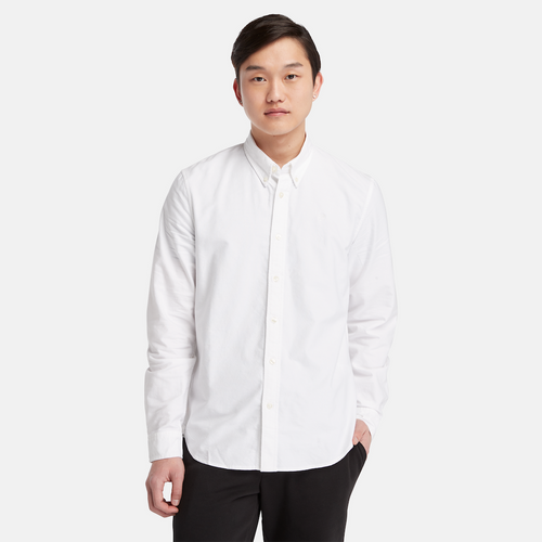 Timberland‚® Long Sleeve Oxford Shirt for Men in White. White oxford shirt featuring a relaxed regular fit for comfortable wear. Made from 100% organic cotton for a soft and breathable feel. Features a mini button-down collar, rounded cuffs, and faux shell buttons for a polished look.  Timberland‚® tree logo embroidered on the chest for subtle branding. Pairs well with jeans, chinos, or dress pants for work, casual outings, or layered looks.
