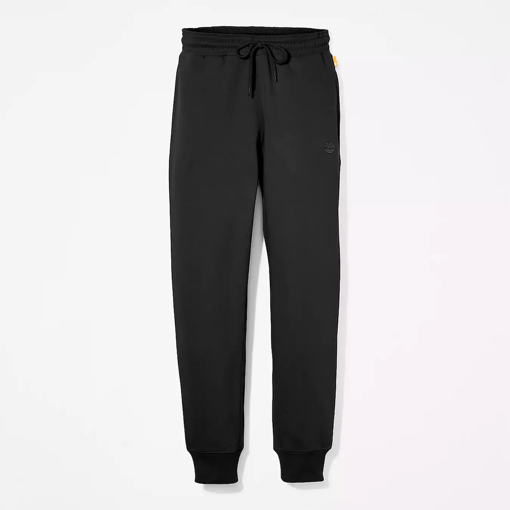 Black Timberland Brushed Back Joggers for Women. Black sweatpants featuring a soft, brushed-back fabric for warmth and comfort.  These joggers offer a relaxed fit with an elasticated drawstring waistband, cuffed ankles, and two handy side pockets