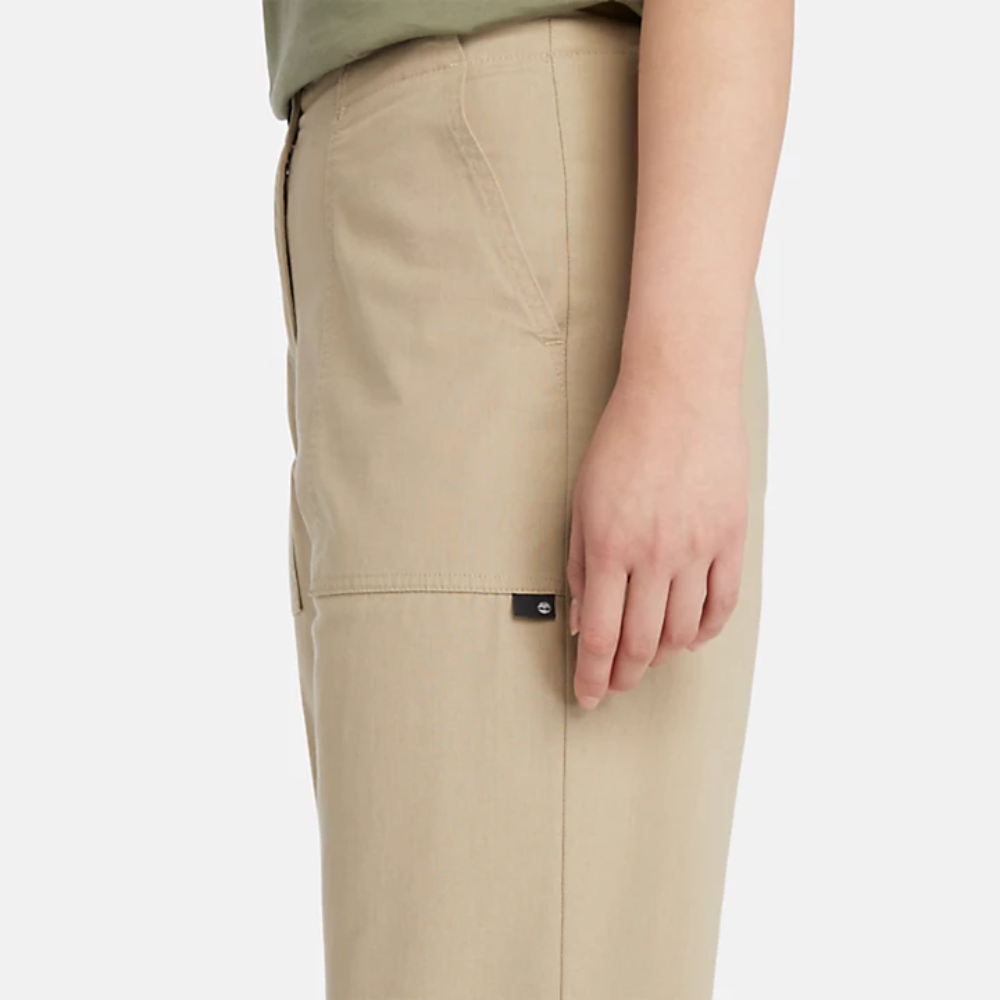 Beige Timberland‚® Utility Fatigue Trousers for Women. Organic cotton and elastane blend for comfort and stretch. Tapered fit. Cargo pocket with flap and side pockets for storage. Button and fly closure. Drawstring hem for adjustability.