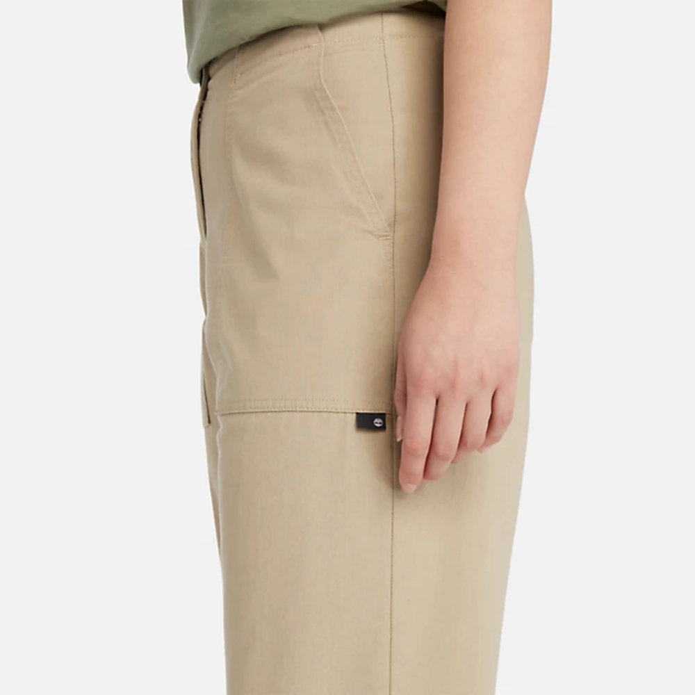 Beige Timberland¡ Utility Fatigue Trousers for Women. Organic cotton and elastane blend for comfort and stretch. Tapered fit. Cargo pocket with flap and side pockets for storage. Button and fly closure. Drawstring hem for adjustability.