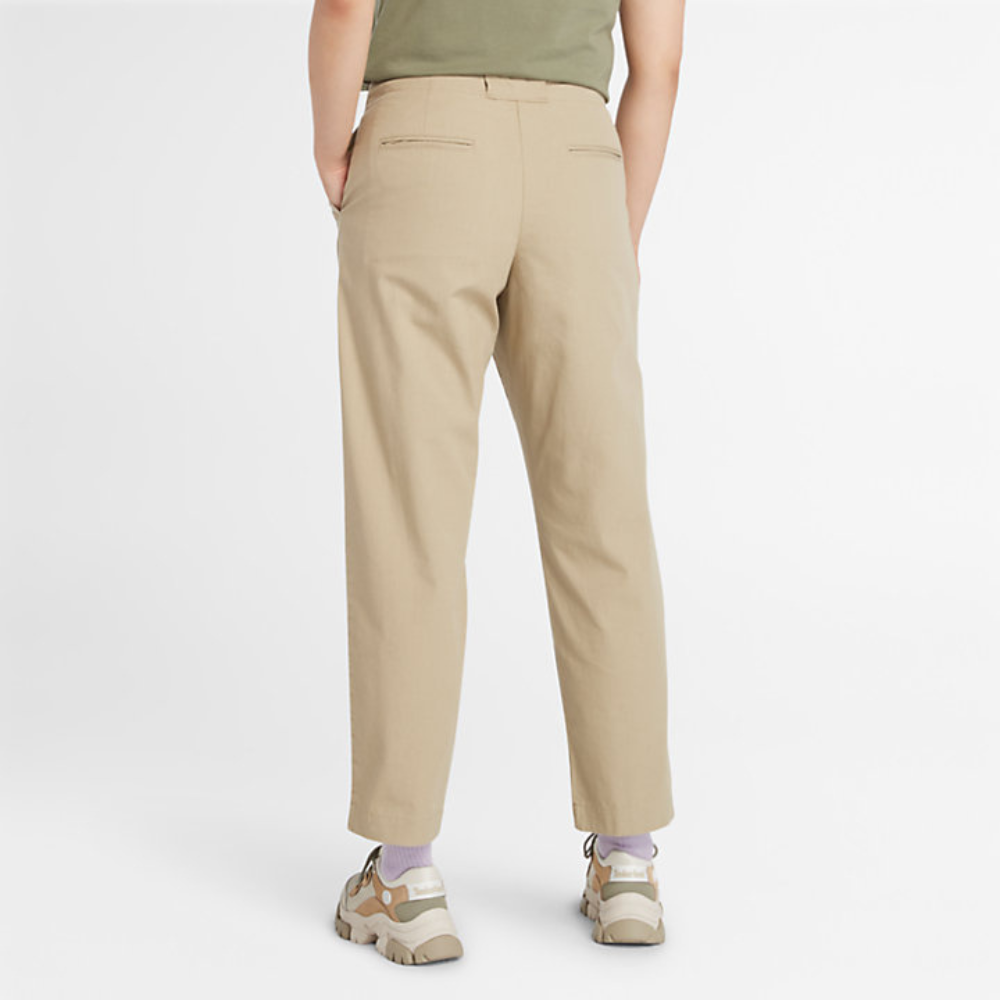 Beige Timberland¡ Utility Fatigue Trousers for Women. Organic cotton and elastane blend for comfort and stretch. Tapered fit. Cargo pocket with flap and side pockets for storage. Button and fly closure. Drawstring hem for adjustability.