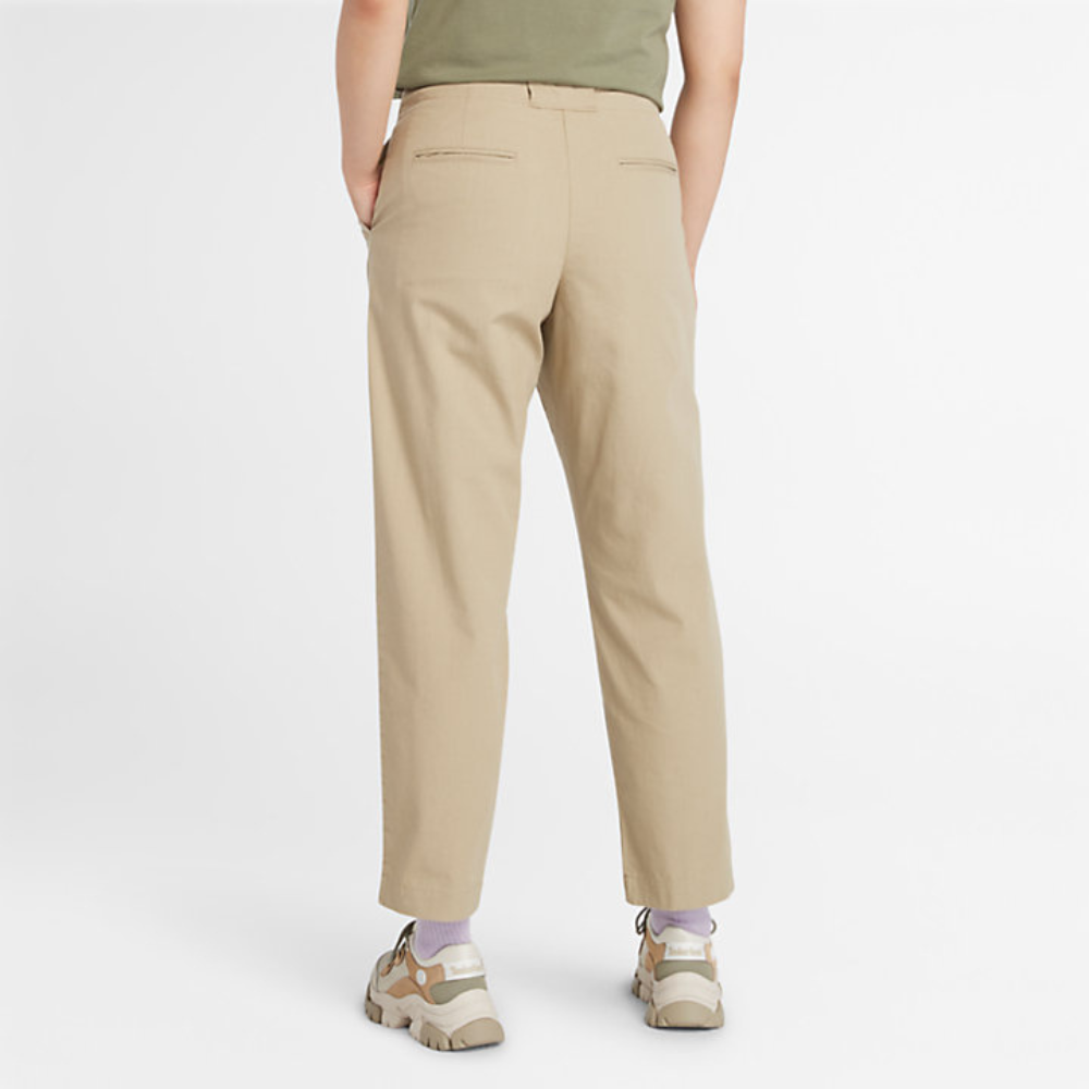 Beige Timberland‚® Utility Fatigue Trousers for Women. Organic cotton and elastane blend for comfort and stretch. Tapered fit. Cargo pocket with flap and side pockets for storage. Button and fly closure. Drawstring hem for adjustability.