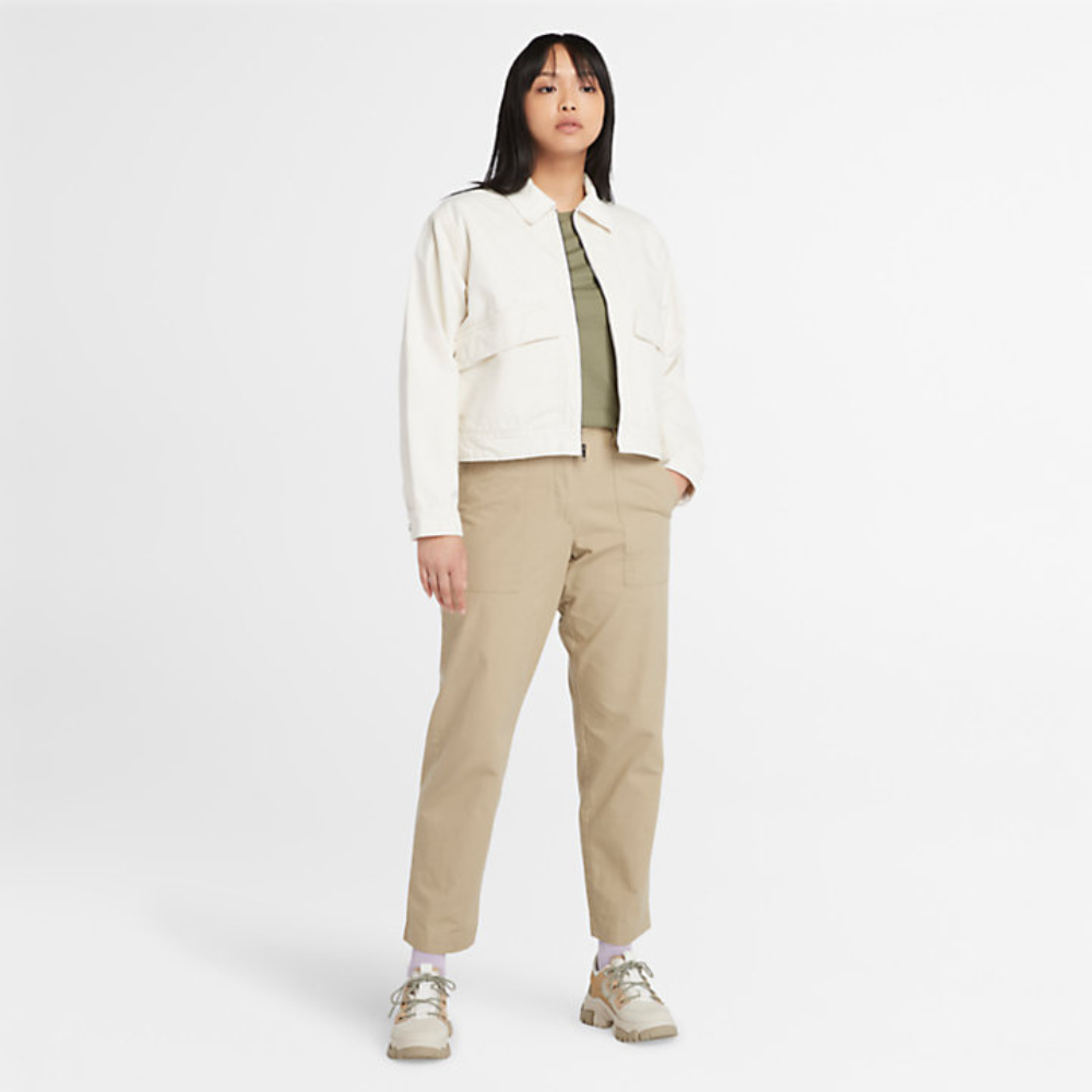Beige Timberland¡ Utility Fatigue Trousers for Women. Organic cotton and elastane blend for comfort and stretch. Tapered fit. Cargo pocket with flap and side pockets for storage. Button and fly closure. Drawstring hem for adjustability.