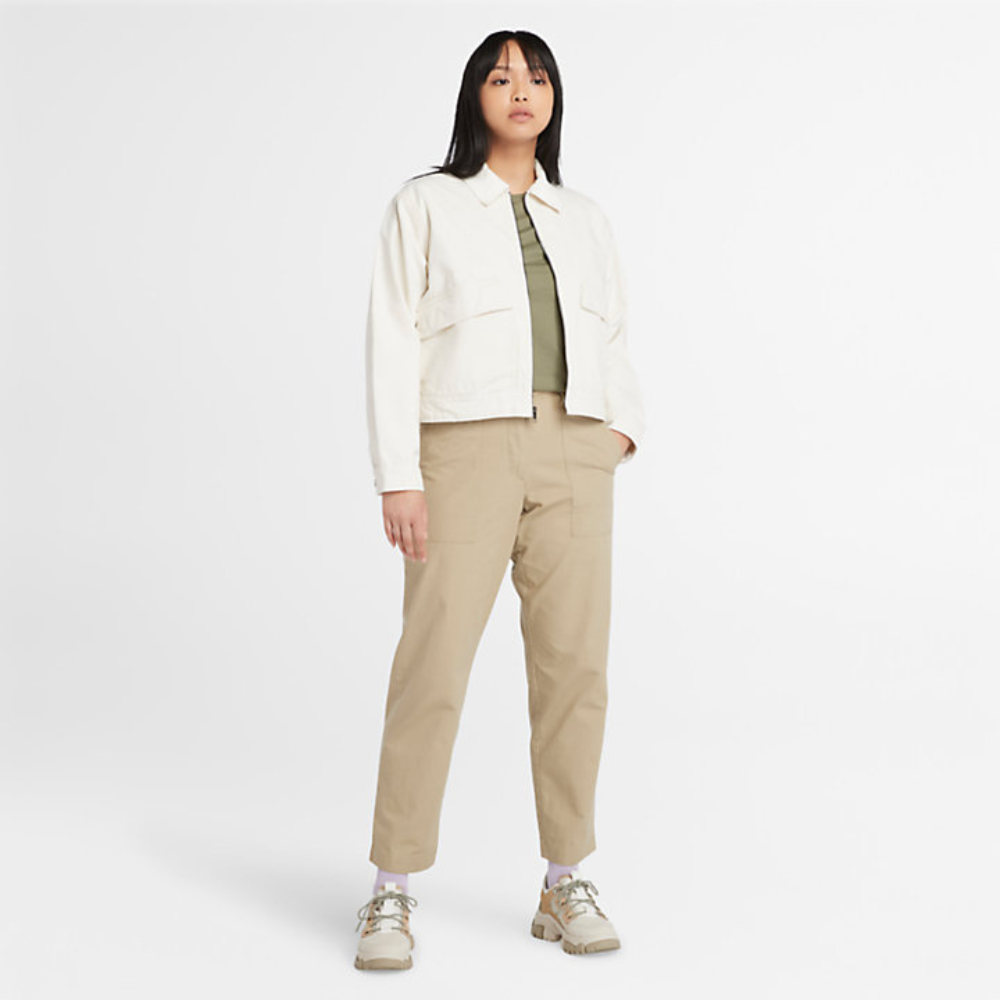 Beige Timberland® Utility Fatigue Trousers for Women. Organic cotton and elastane blend for comfort and stretch. Tapered fit. Cargo pocket with flap and side pockets for storage. Button and fly closure. Drawstring hem for adjustability.